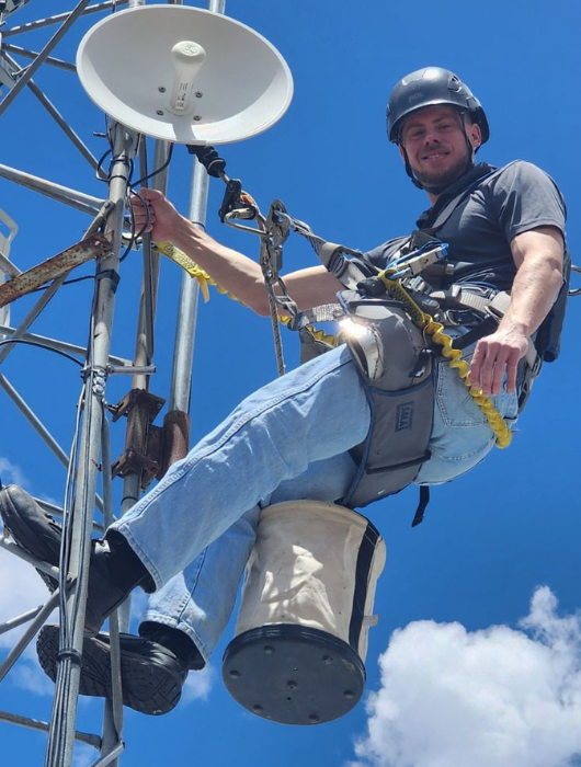 Ryan Merrill climbing a tower